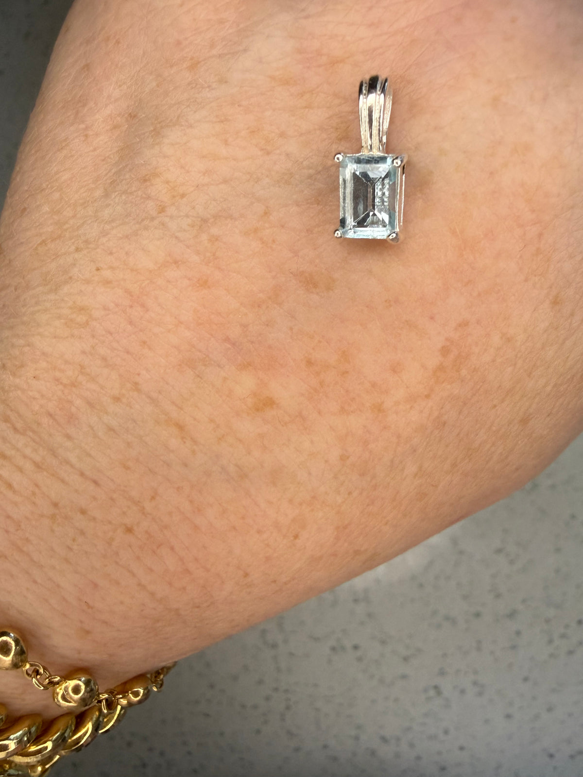 Sterling silver blue topaz emerald cut pendant